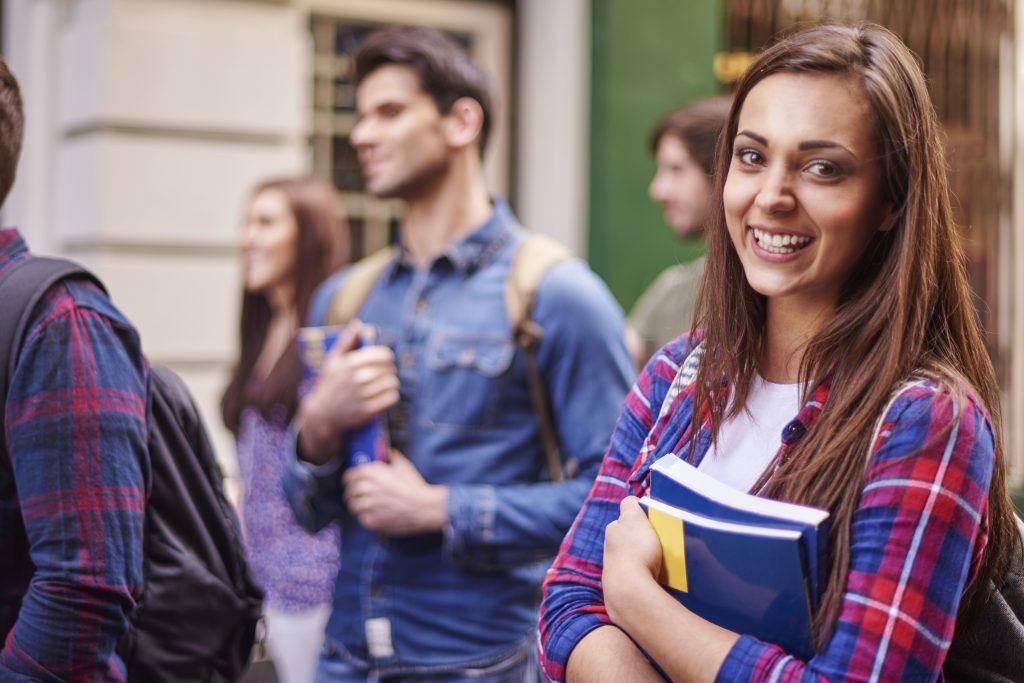 student holding books