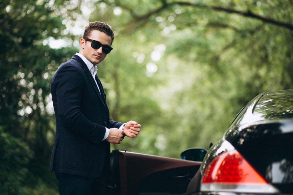 rich man in front of car