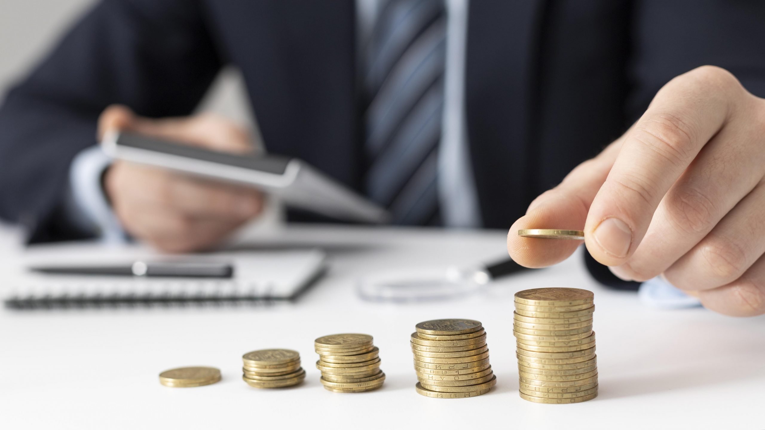 man stacking coins