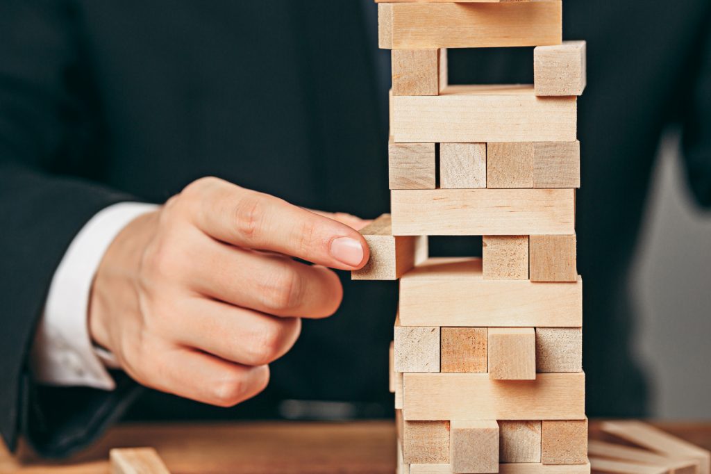 man-wooden-cubes-table-management-concept (1)