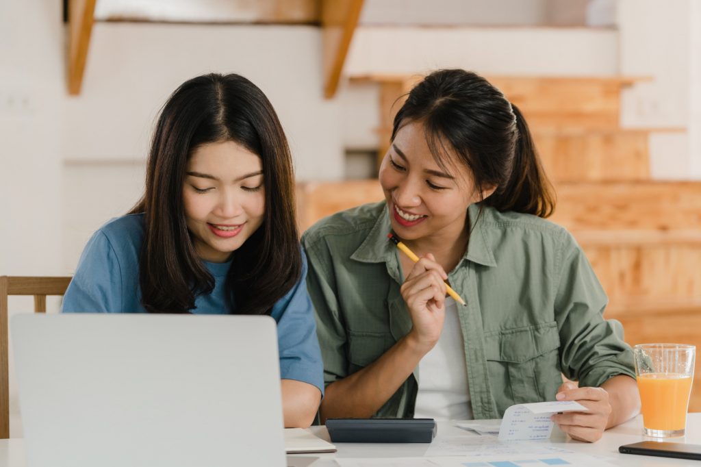 couple looking at computer making budget