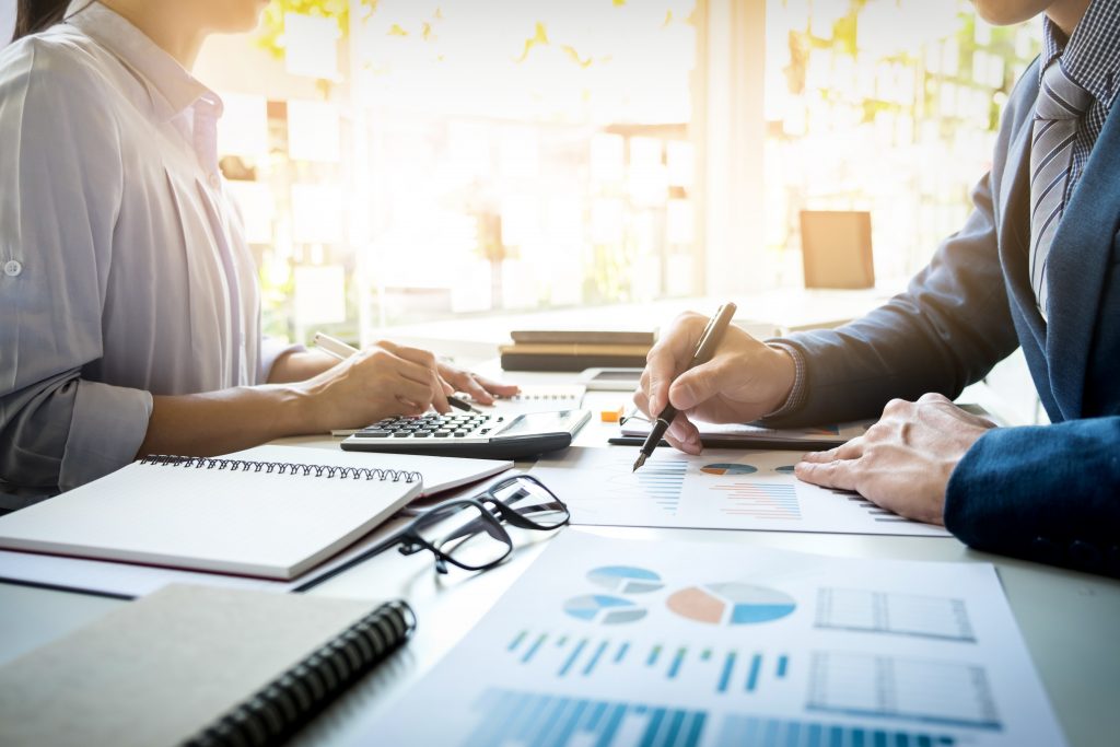 couple analyzing reports for budget