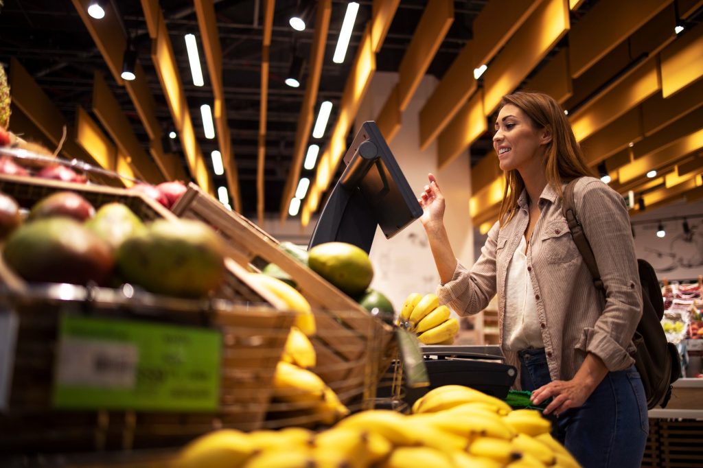 woman at supermarket using self service