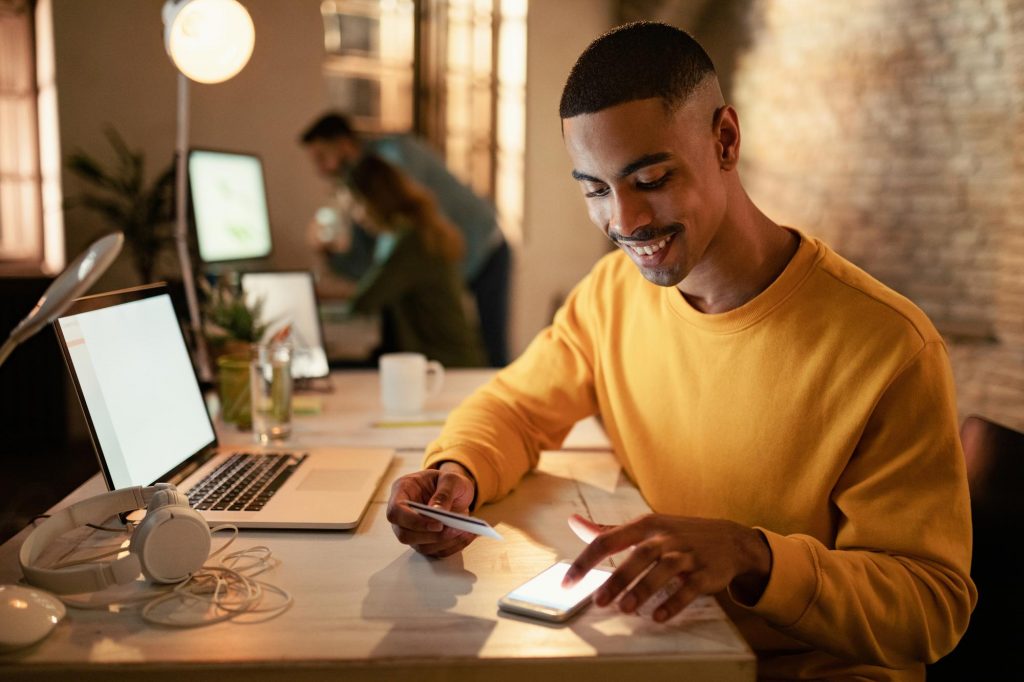 happy man using secured credit card online