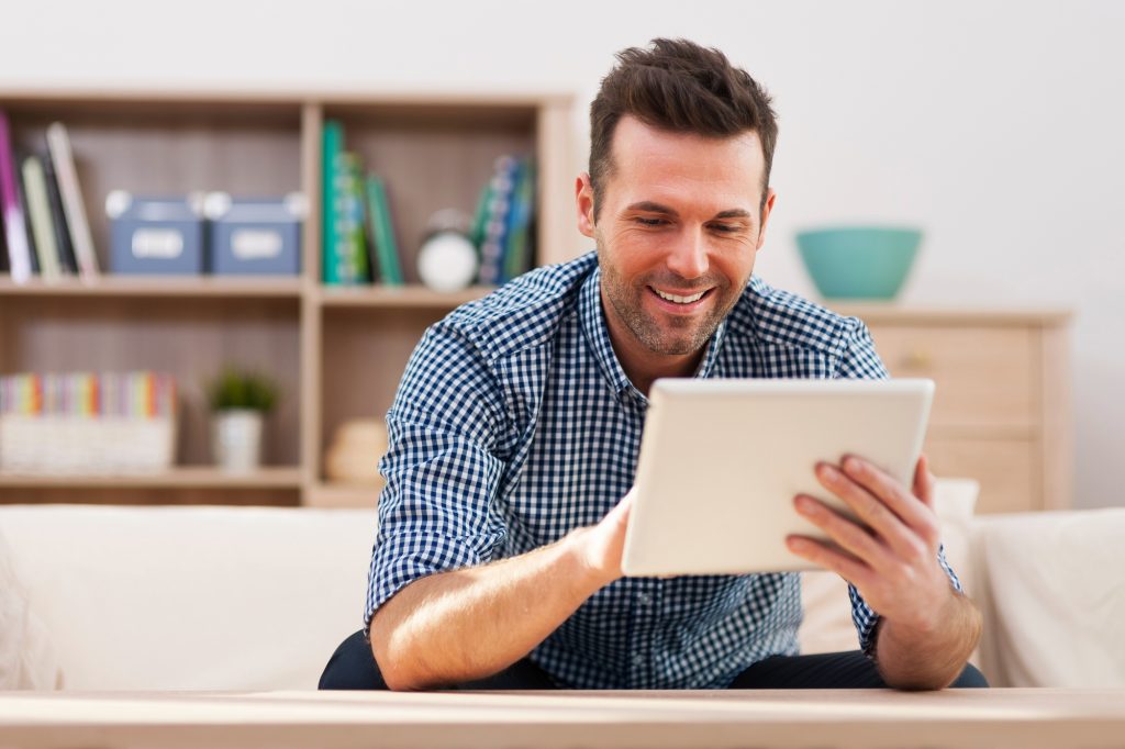 smiling man using tablet