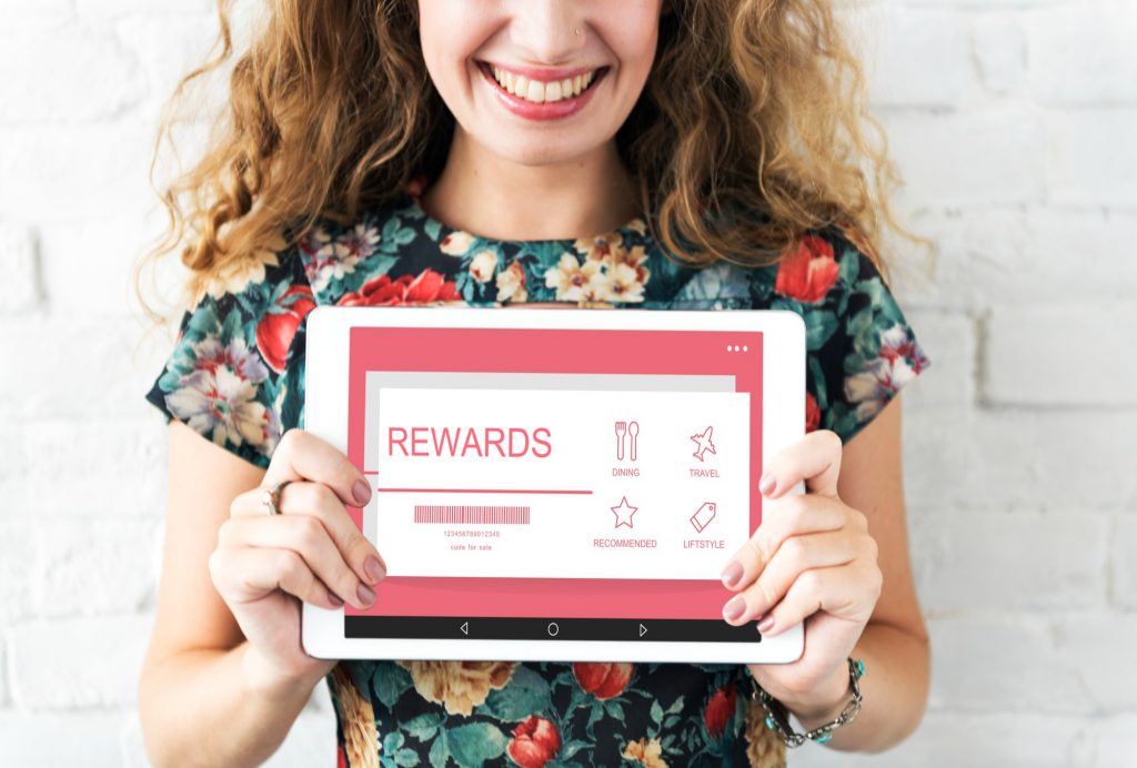 woman holding rewards voucher