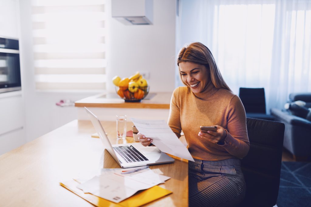 woman smiling holding papers