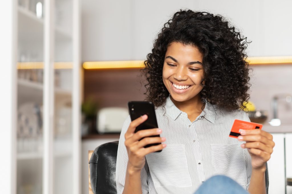 African American teenage girl holding credit card