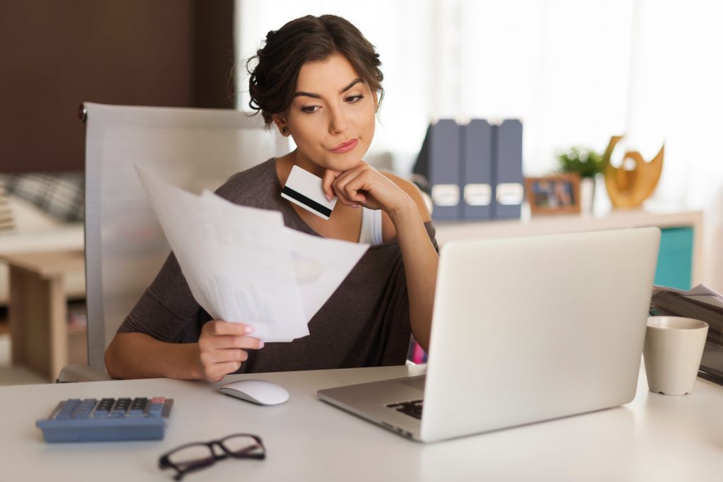 woman paying bills at home