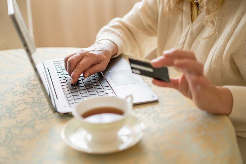 woman using credit card to shop online