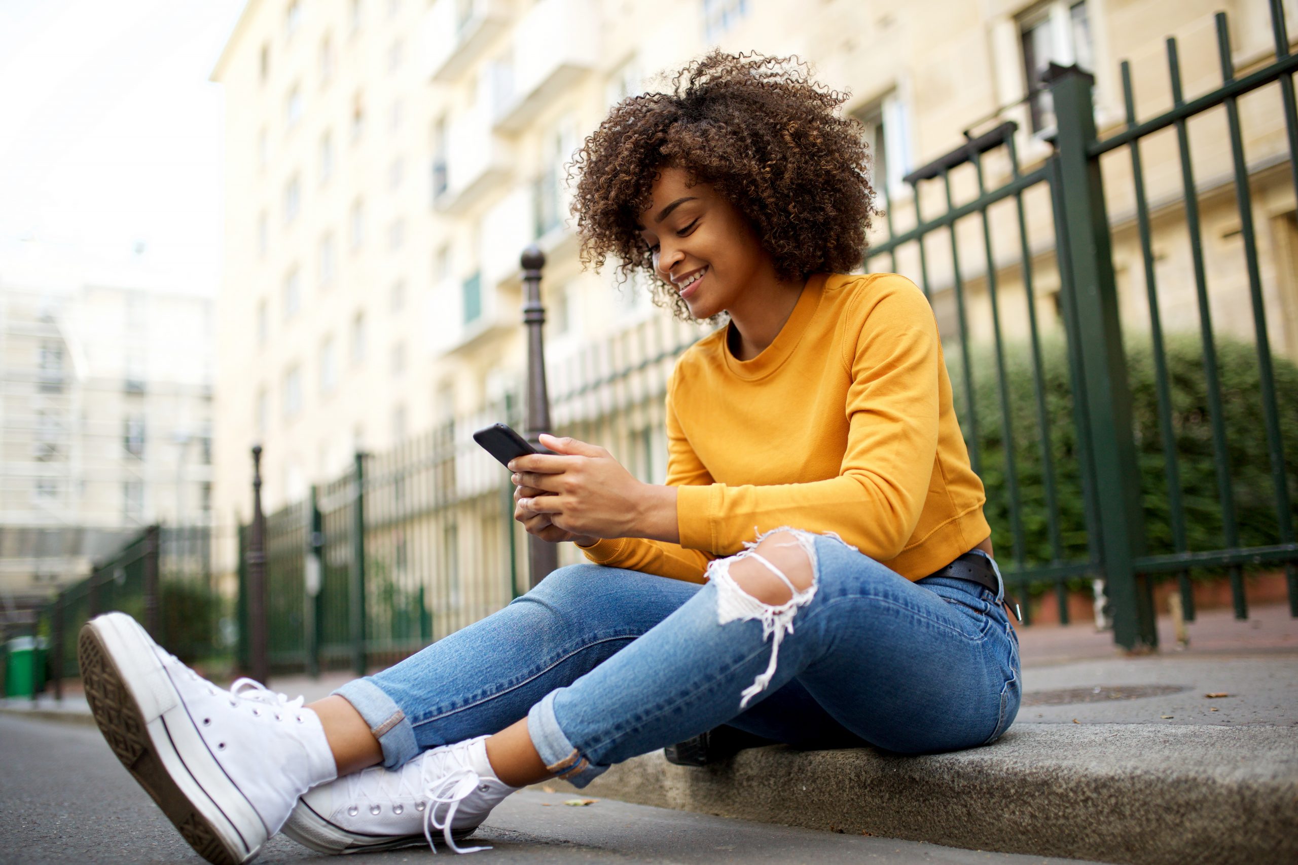 woman using cellphone on the sidewalk