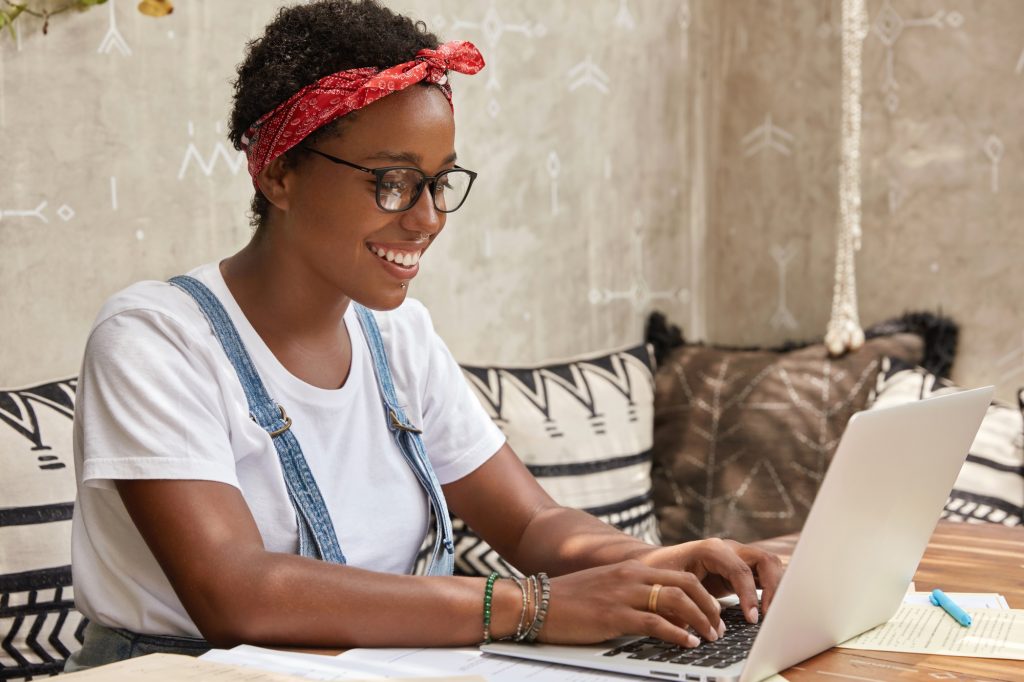 smiling student using laptop