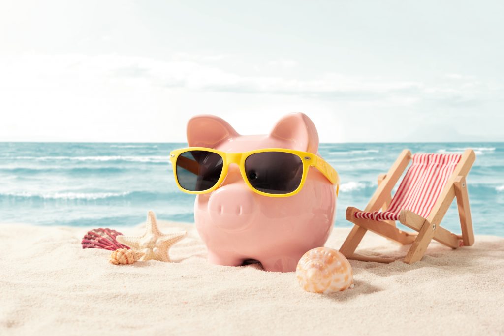 Piggy bank resting on vacation. Saving money, travel concept