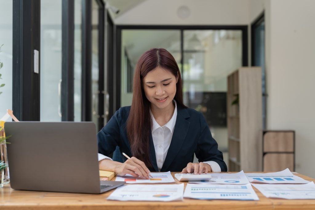 Financial Business woman analyze the graph of the company's performance to create profits and growth, Market research reports and income statistics, Financial and Accounting concept