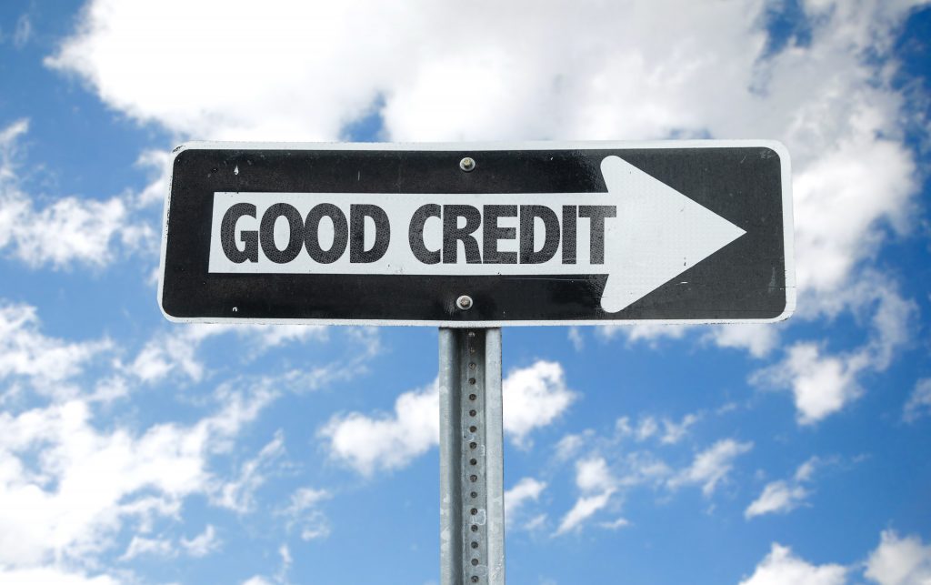 Good Credit direction sign with sky background