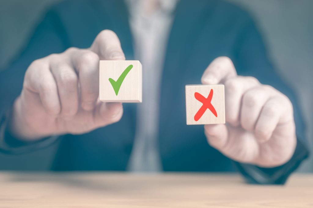 Accept and Decline. making decision pros and cons. Choices Tick Yes No Choose Mark Decision. businessman makes decision, Hands of businessman chooses checkmark and x sign symbol on wooden cube block