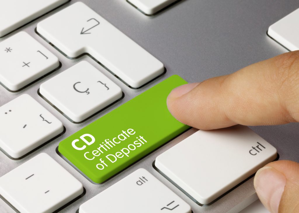 CD Certificate of Deposit Written on Green Key of Metallic Keyboard. Finger pressing key.