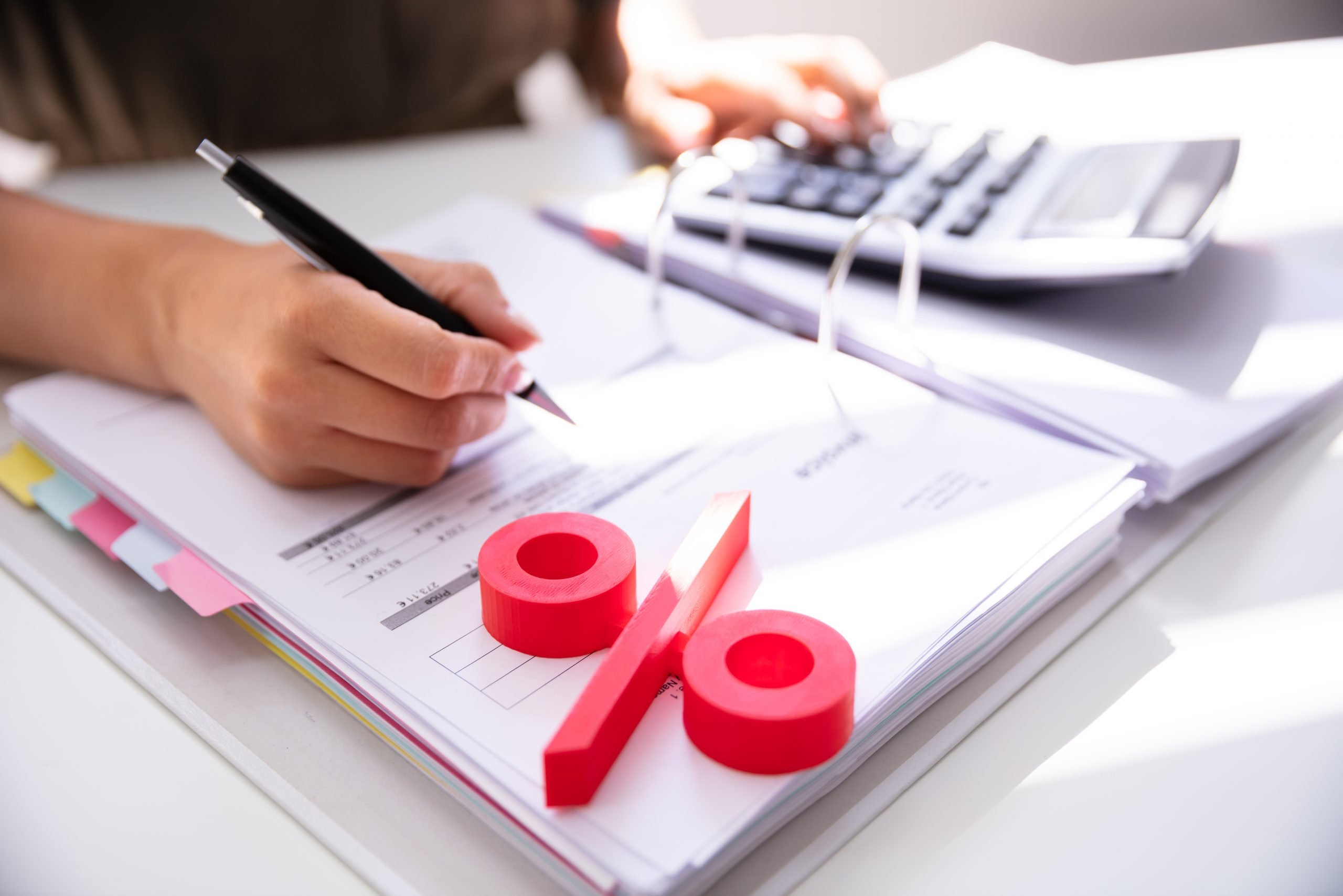 Businessperson's Hand Calculating Bill With Calculator