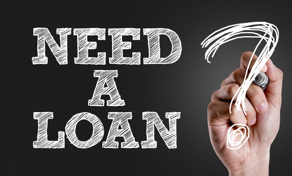 Hand writing the text: Need a Loan?
