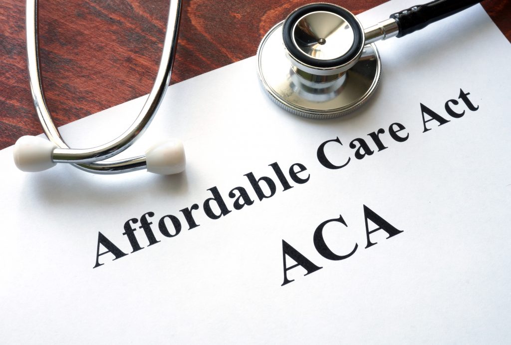 Words Affordable Care Act ACA written on a paper.