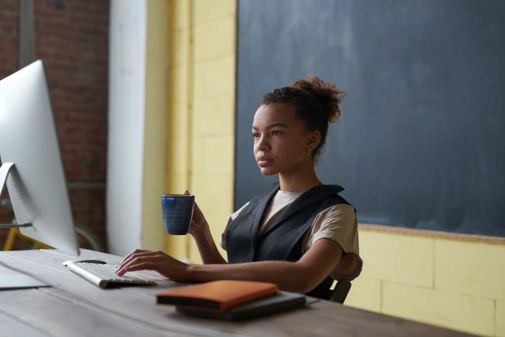 Black woman wising her computer