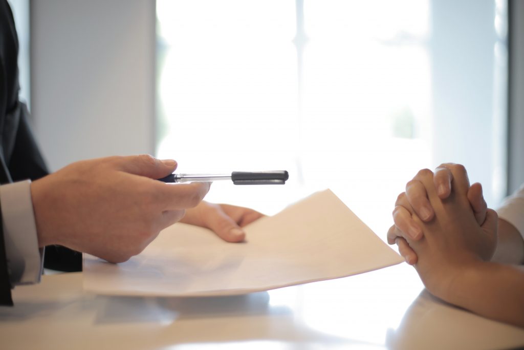 female hand pointing a pen