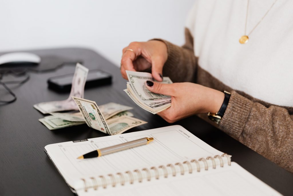 female hand, holding and counting cash