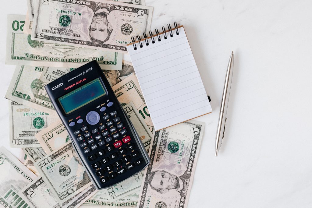 top view of a calculator and notebook