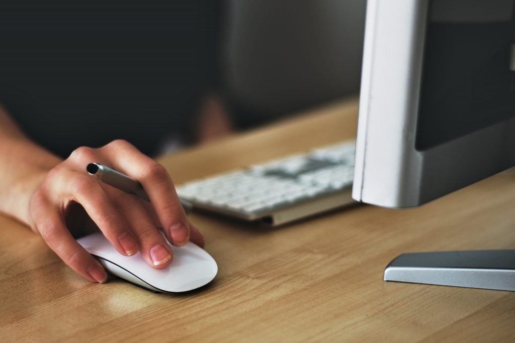 Female hand using a mouse