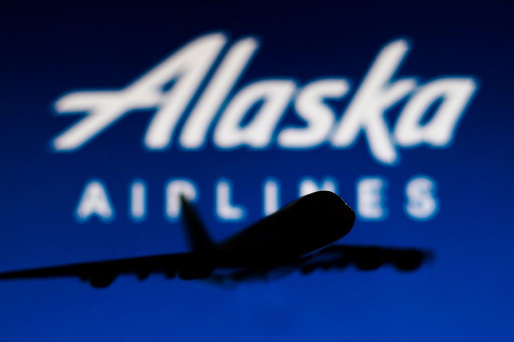 May 25, 2022, Brazil. In this photo illustration, the silhouette of an Airbus A380 plane with the Alaska Airlines company logo in the background