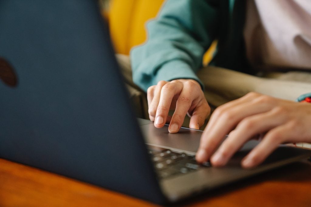 male hands typing in a computer