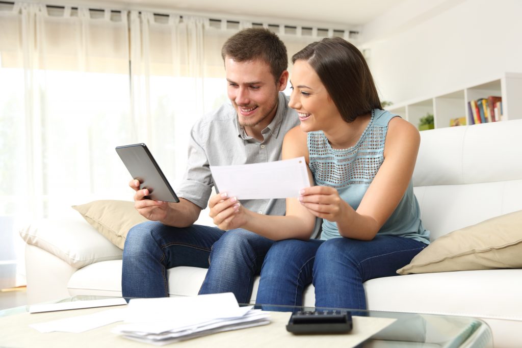 Happy couple checking bank account online