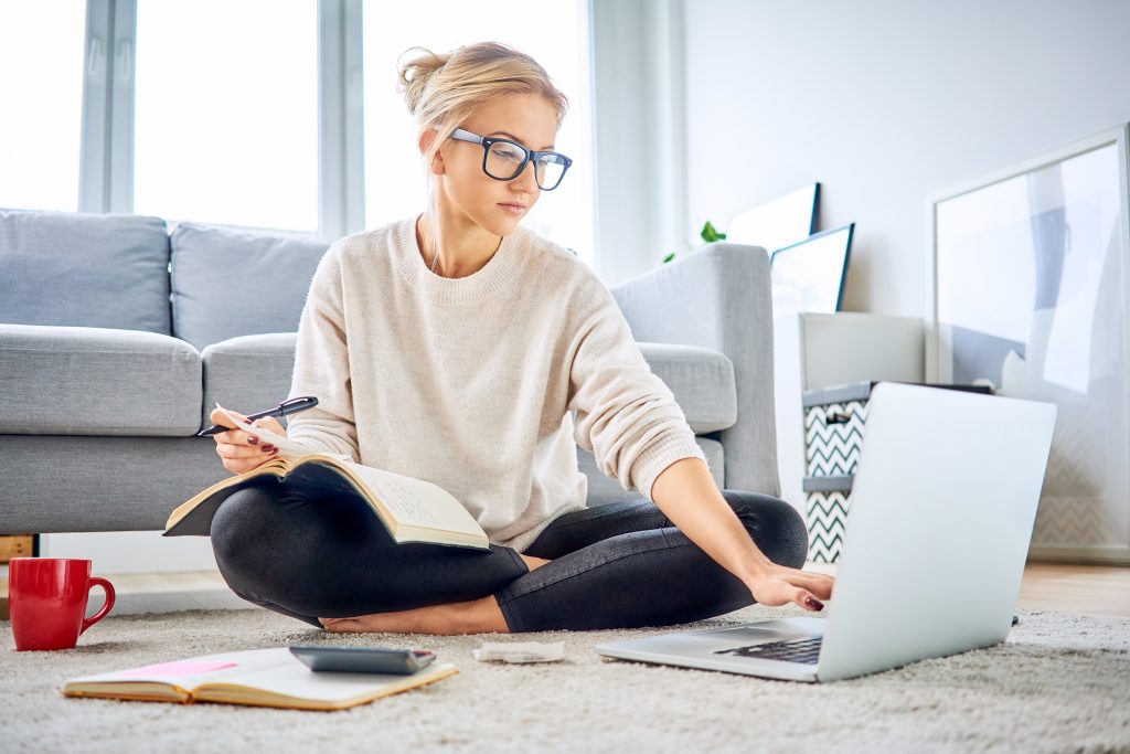 Woman using laptop paying bills online and managing home budget
