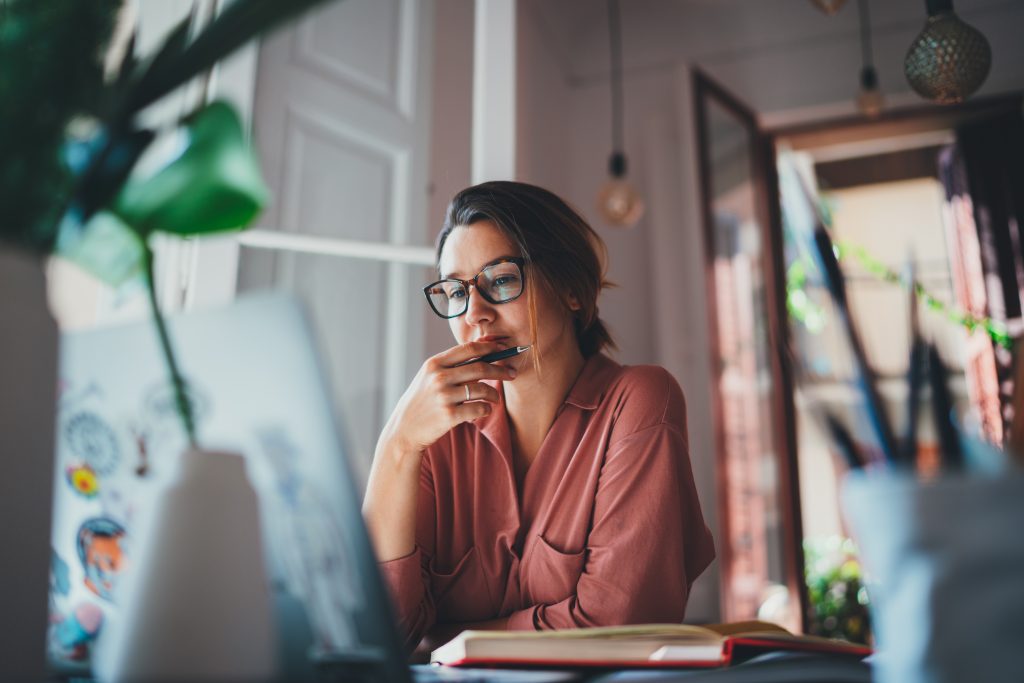 Young businesswoman thinking about something while sitting front