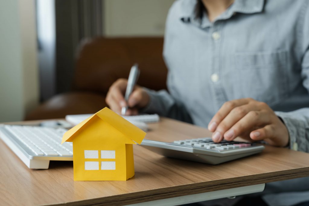 Business Finance concept. Close up yellow paper house model wit