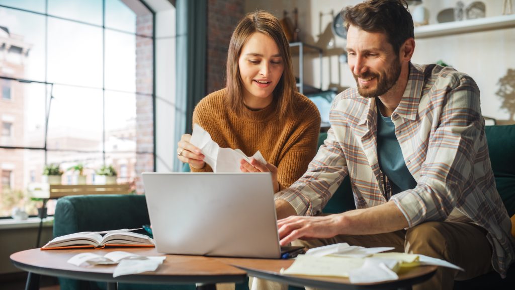 Doing Accounting at Home: Happy Couple Using Laptop Computer, Si