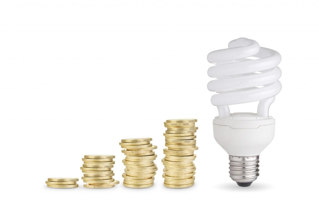 Money saved with energy saver bulb. Isolated on white background