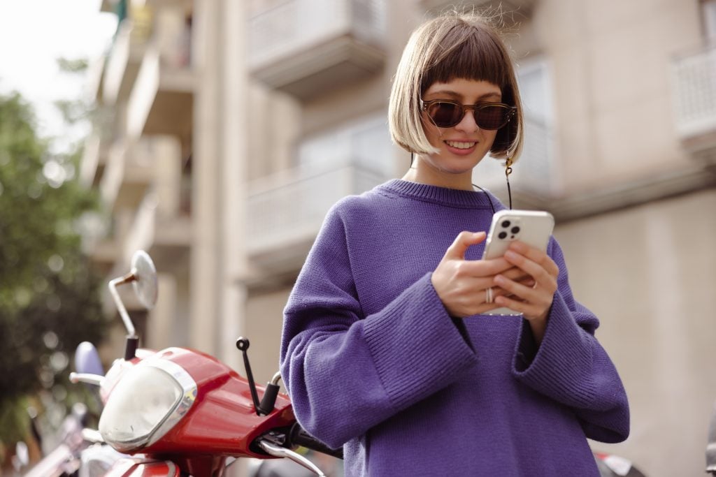view-smiling-woman-looking-phone