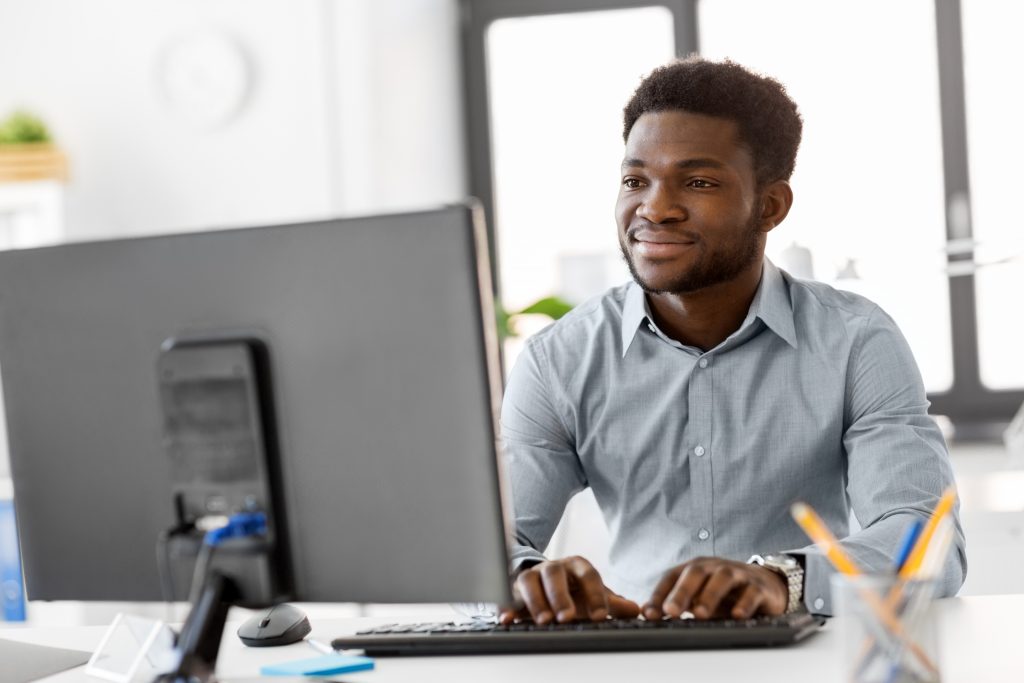 african businessman with computer at office