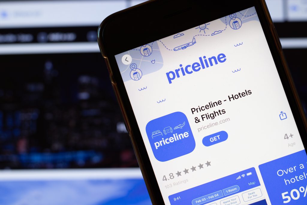 Los Angeles, California, USA - 24 March 2020: Priceline app logo on phone screen close up with website on background with icon, Illustrative Editorial