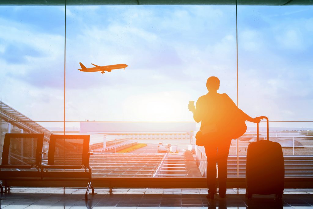 happy traveler waiting for the flight in airport, departure term