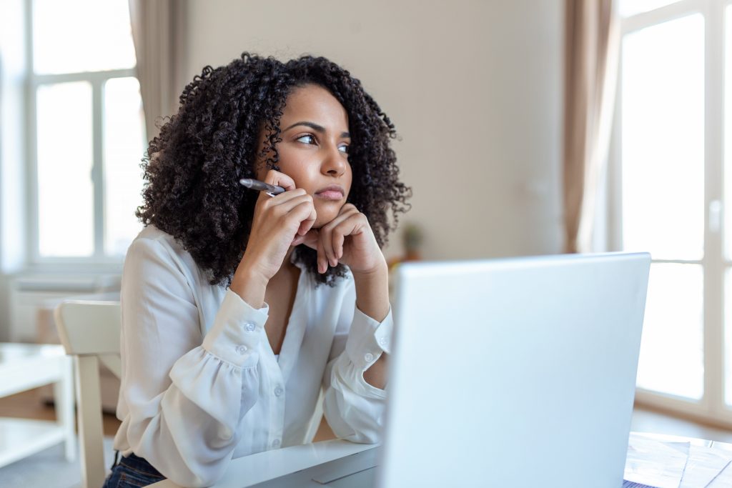 Confused businesswoman annoyed by online problem, spam email or fake internet news looking at laptop, female office worker feeling shocked about stuck computer, bewildered by scam message or virus