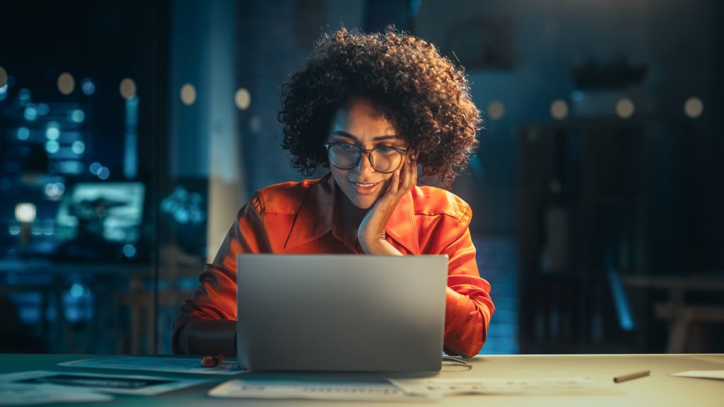 Portrait of a Happy Successful Businesswoman Using Laptop Comput