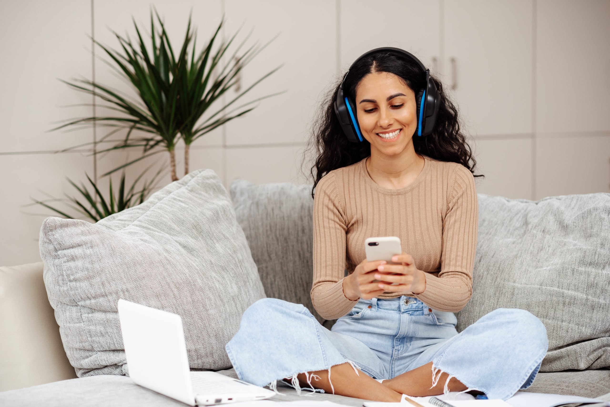 Woman using cellphone on the sofa