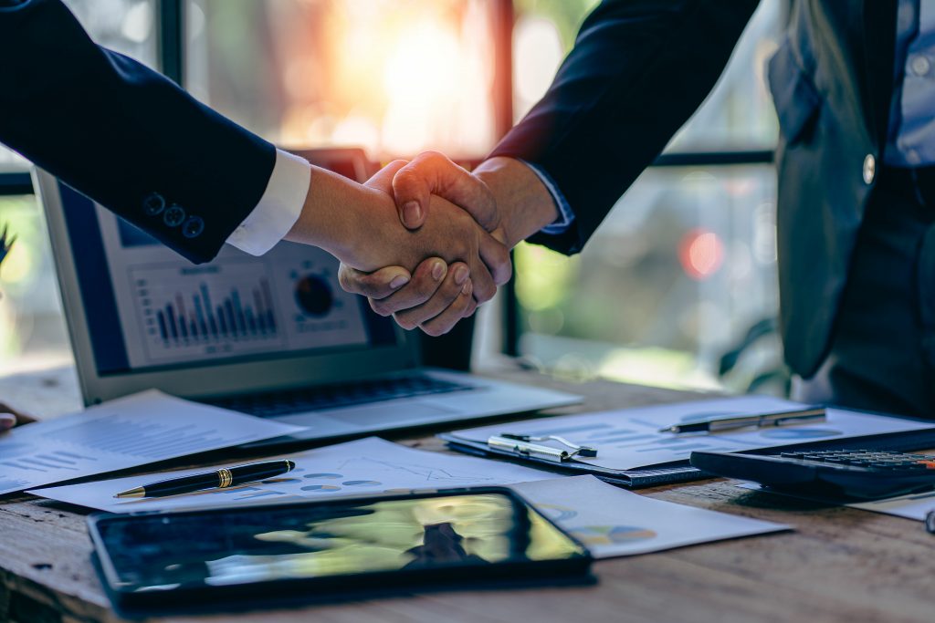 Young businessman and businesswoman in investment agreement, two