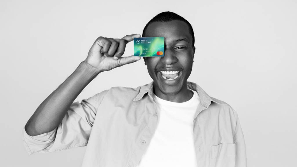 black and white picture of a black man smiling and holding the First Latitude Select Mastercard® Secured Card
